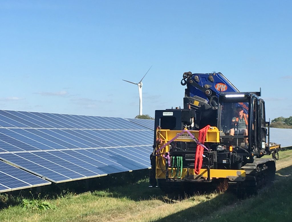 Solar Field, Wind Turbine and Tracked Machine with Crane